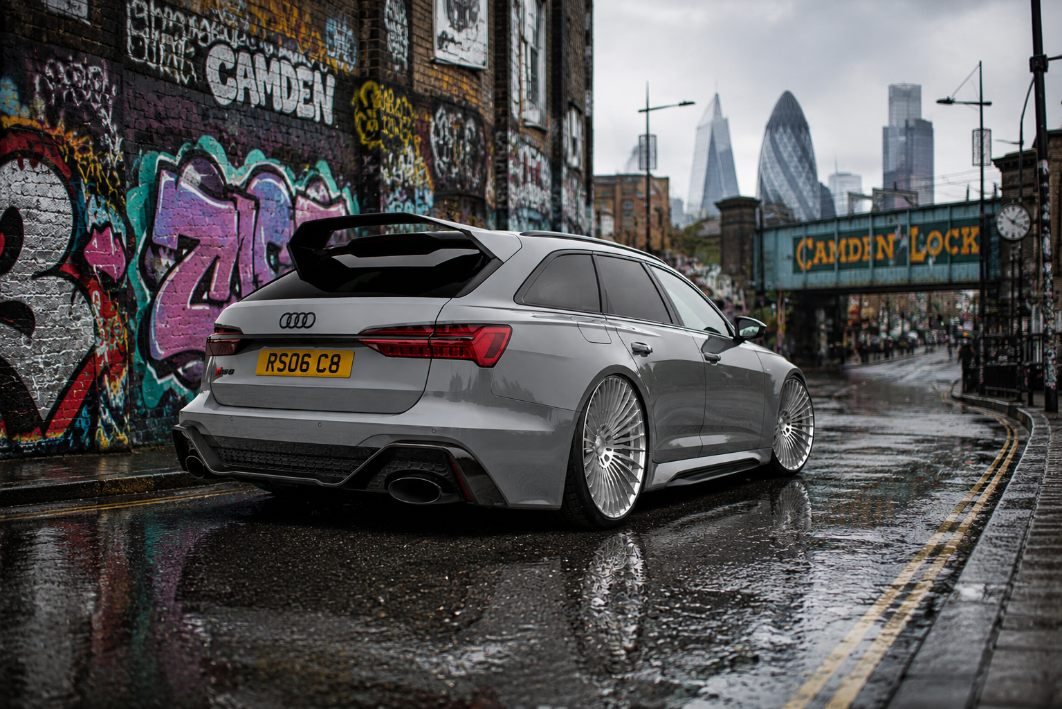 Nardo grey Audi RS6 Avant lowered on large multi-spoke forged wheels with carbon fibre rear spoiler