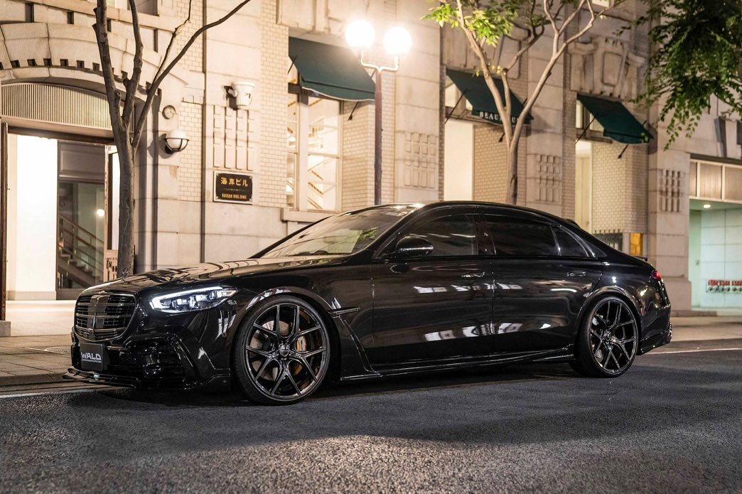 Black Mercedes-Benz S-Class with a Wald International body kit and gloss black forged wheels at night